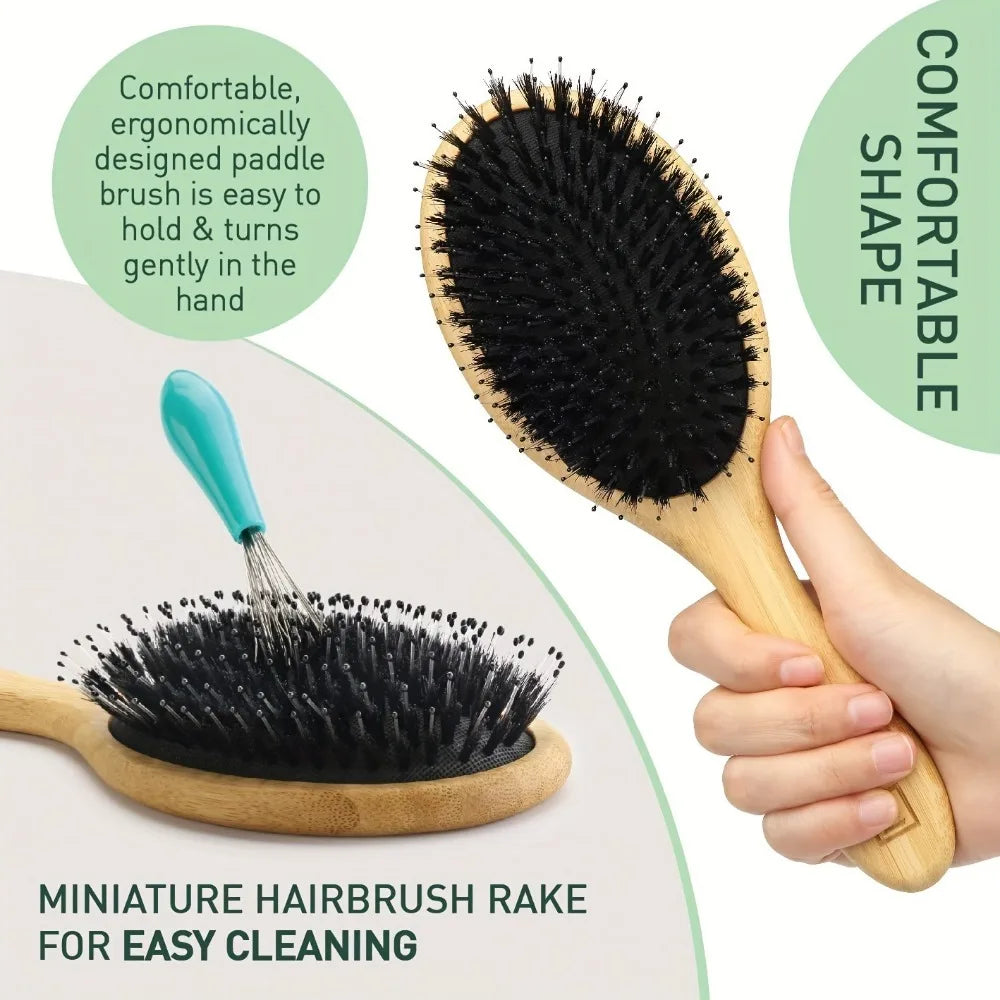 A wooden miniature hairbrush rake with black boar bristles shown being held by a hand.