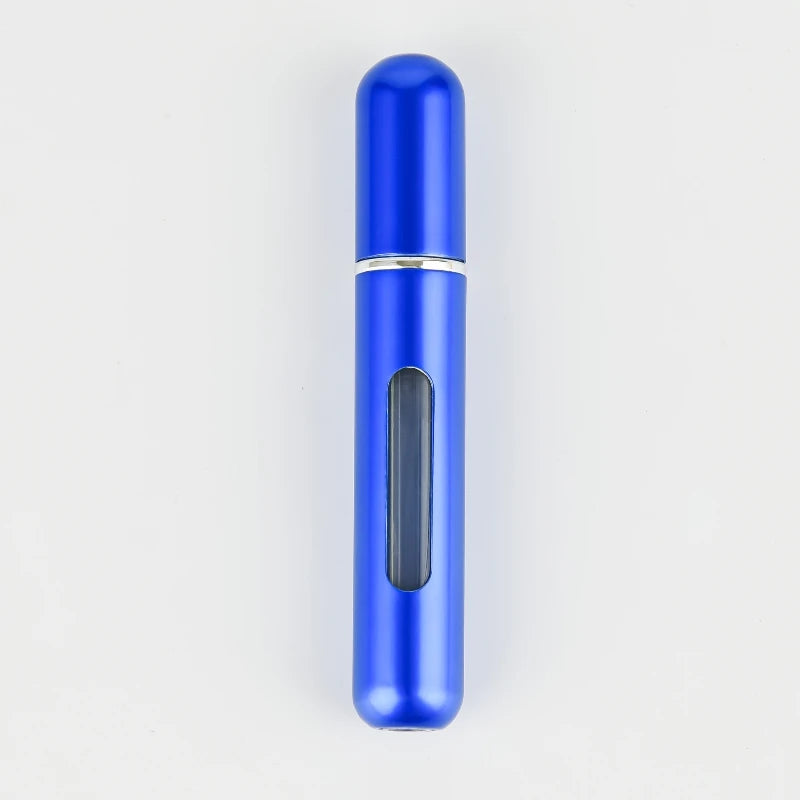A sleek, cylindrical blue portable refillable perfume bottle with a silver band and a black dispensing mechanism.