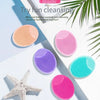 A collection of various colored silicone facial cleansing brushes and a starfish are displayed on a white background.