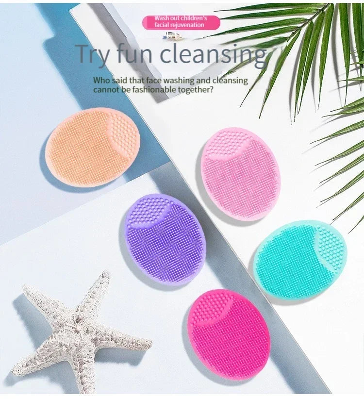 A collection of various colored silicone facial cleansing brushes and a starfish are displayed on a white background.