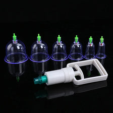 A white professional vacuum cupping therapy set with multiple glass cups and nozzles displayed on a black surface.