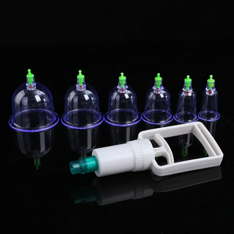 Un kit professionnel de vacuum cupping blanc avec plusieurs tasses et buses en verre, exposé sur une surface noire.