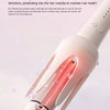 A close-up of a pink hair straightener with a rotating ceramic barrel emitting red light and moisture onto hair.