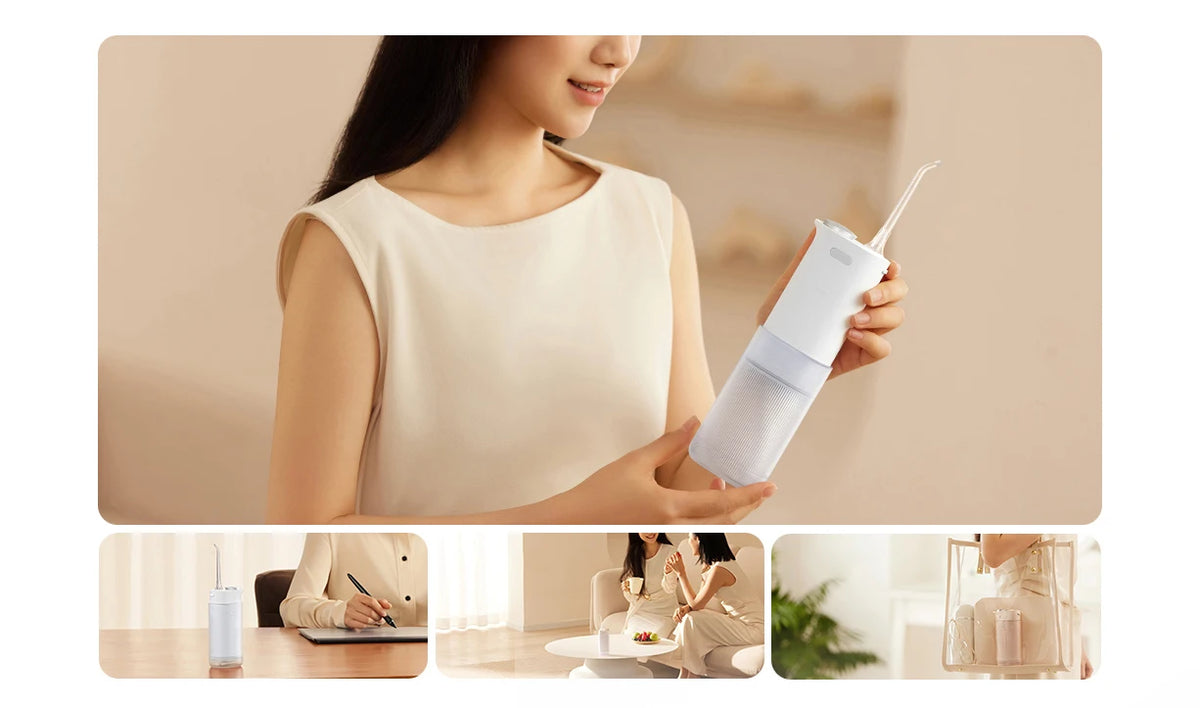 A woman is using a white portable cordless oral irrigator device for cleaning.
