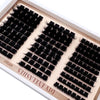 A tray of DIY D-Curl eyelash clusters showing various lash styles and lengths.