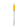 A clear glass bottle with a gold cap and a precision brush for cleaning eyelash extensions.