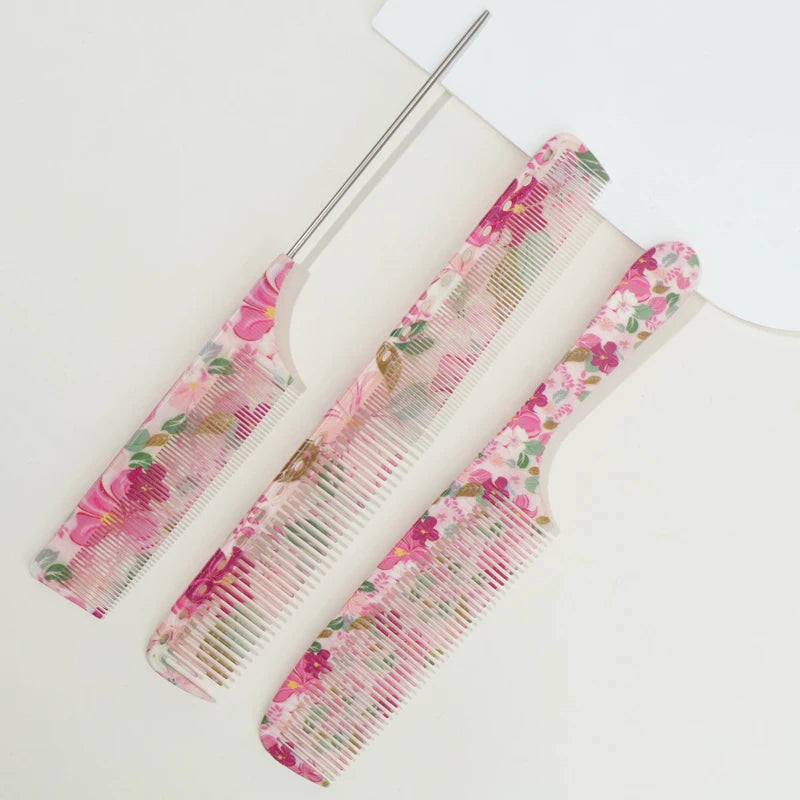A pink floral comb set with a metal comb and plastic comb lying on a white surface.