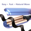 A close-up of a blue ceramic hair waver with a rose gold finish and black hair wrap.