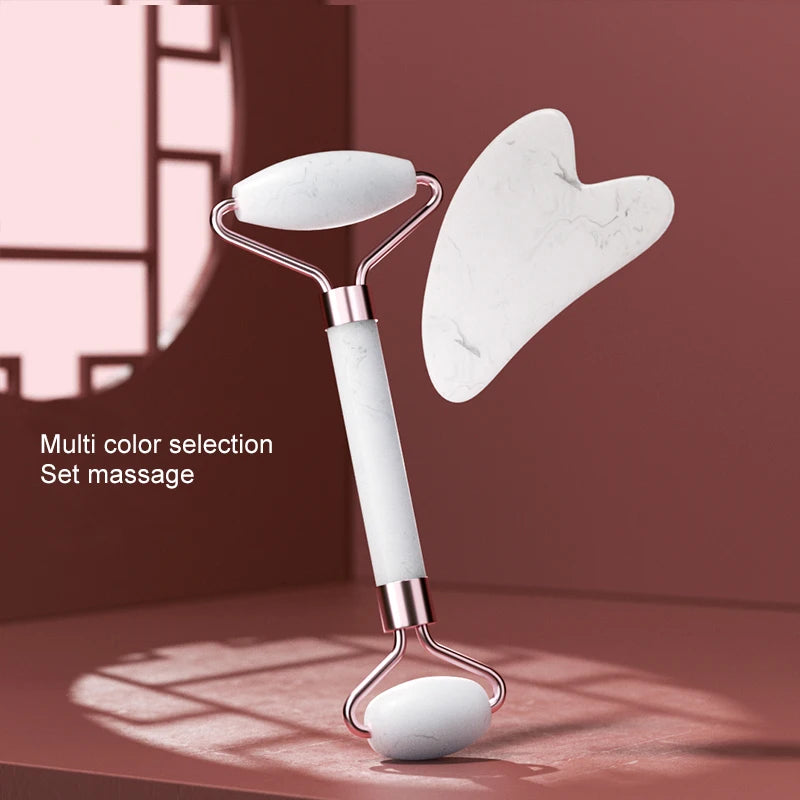 A set of resin facial massage rollers with white and pink marble designs shown against a reddish background.