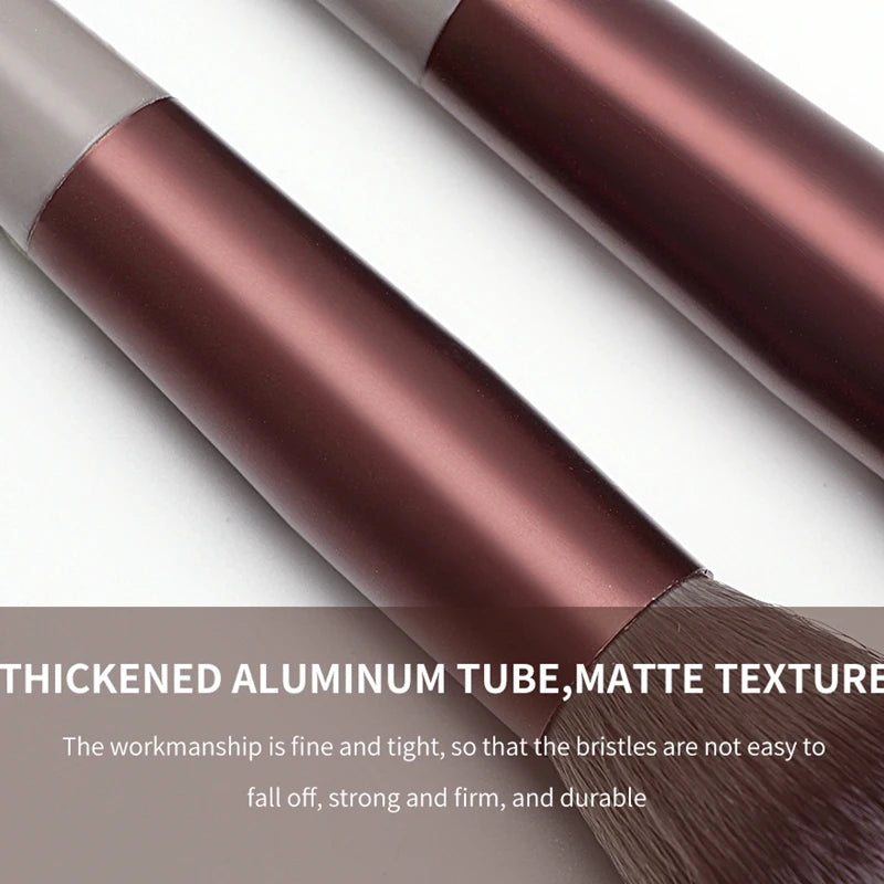 A close-up of a professional makeup brush with a matte finish and thickened aluminum tube.