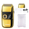 A gold and black all-in-one electric shaver with twin blades and accessories shown on a white background.