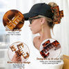 A woman is shown wearing a black baseball cap with tortoiseshell hair clips securing her hair. The clips are designed to fit 