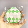 A pink and green checkered makeup puff set packaged in a clear plastic storage bag.