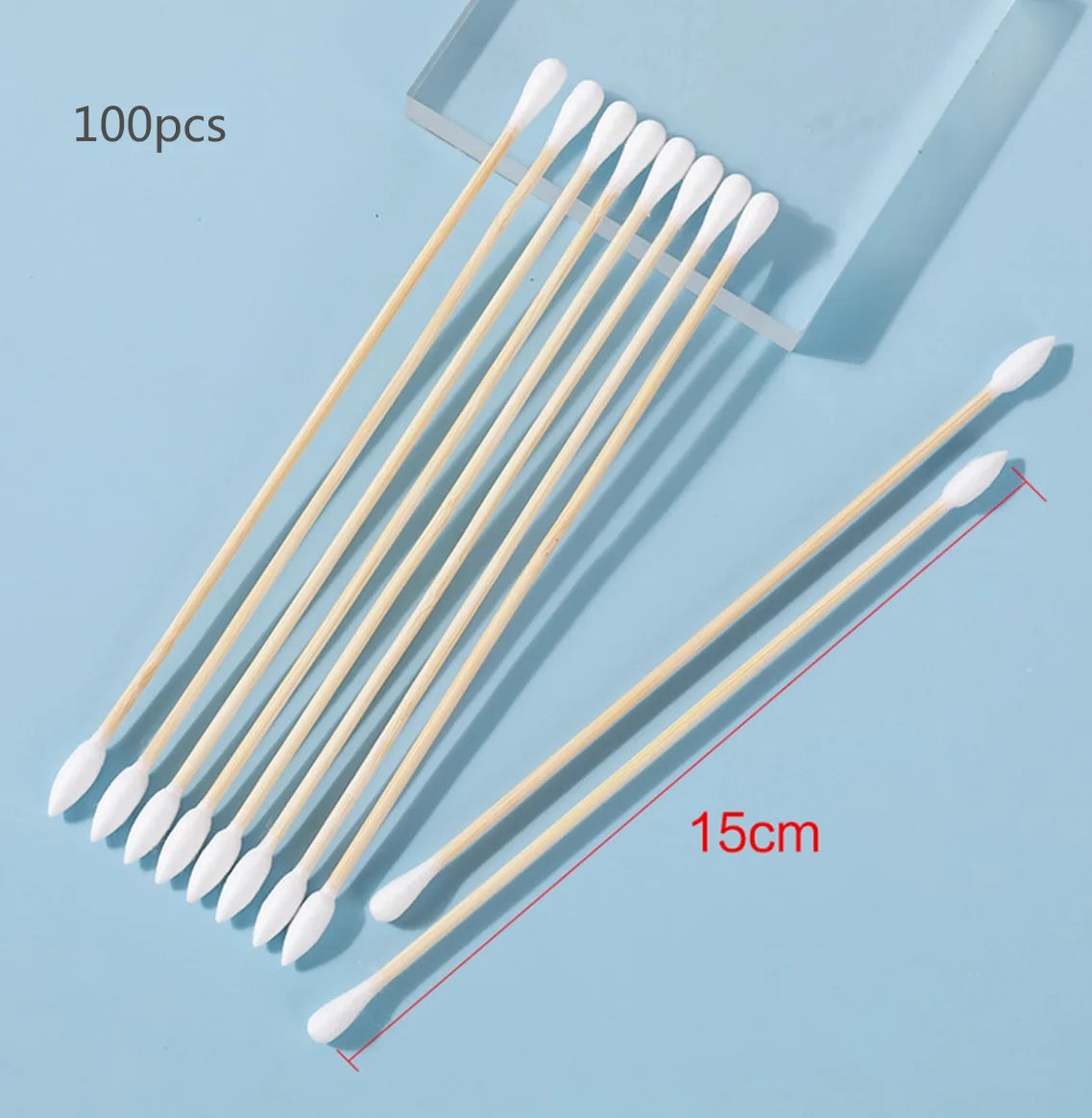 A collection of 100 precision wooden cotton swabs arranged diagonally on a light blue background.