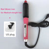 A pink hair straightener with a red 26mm iron and black cord, shown next to a US plug.