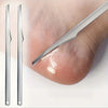 A set of multi-piece stainless steel foot care tools shown next to a human foot.