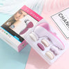 A pink and white box containing a 5-in-1 electric facial cleaning brush and accessories on a light blue surface.