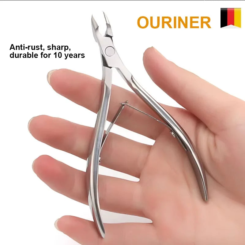 A pair of professional stainless steel cuticle nail nippers held in a person's hand.
