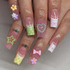 A set of press-on nails featuring a pastel pink and green gradient with decorative stars and hearts.