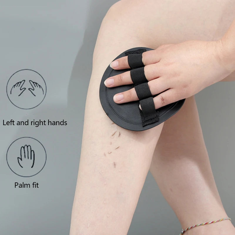 A hand is applying a black silicone grip to a person's arm, demonstrating a palm fit for a natural PVA body scrubbing shower 