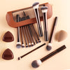 A set of thirteen professional makeup brushes in various shades and sizes displayed with a brown storage case.