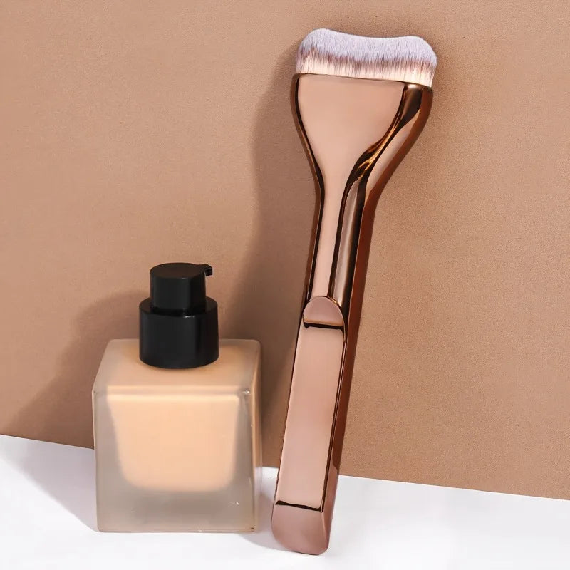 A professional foundation brush with soft nylon bristles displayed against a neutral background.