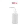 A white plastic bottle for eyelash extension cleaning with a precision applicator brush.