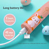 A pink sonic electric toothbrush with a white cord and a small white component is shown against a light blue background.