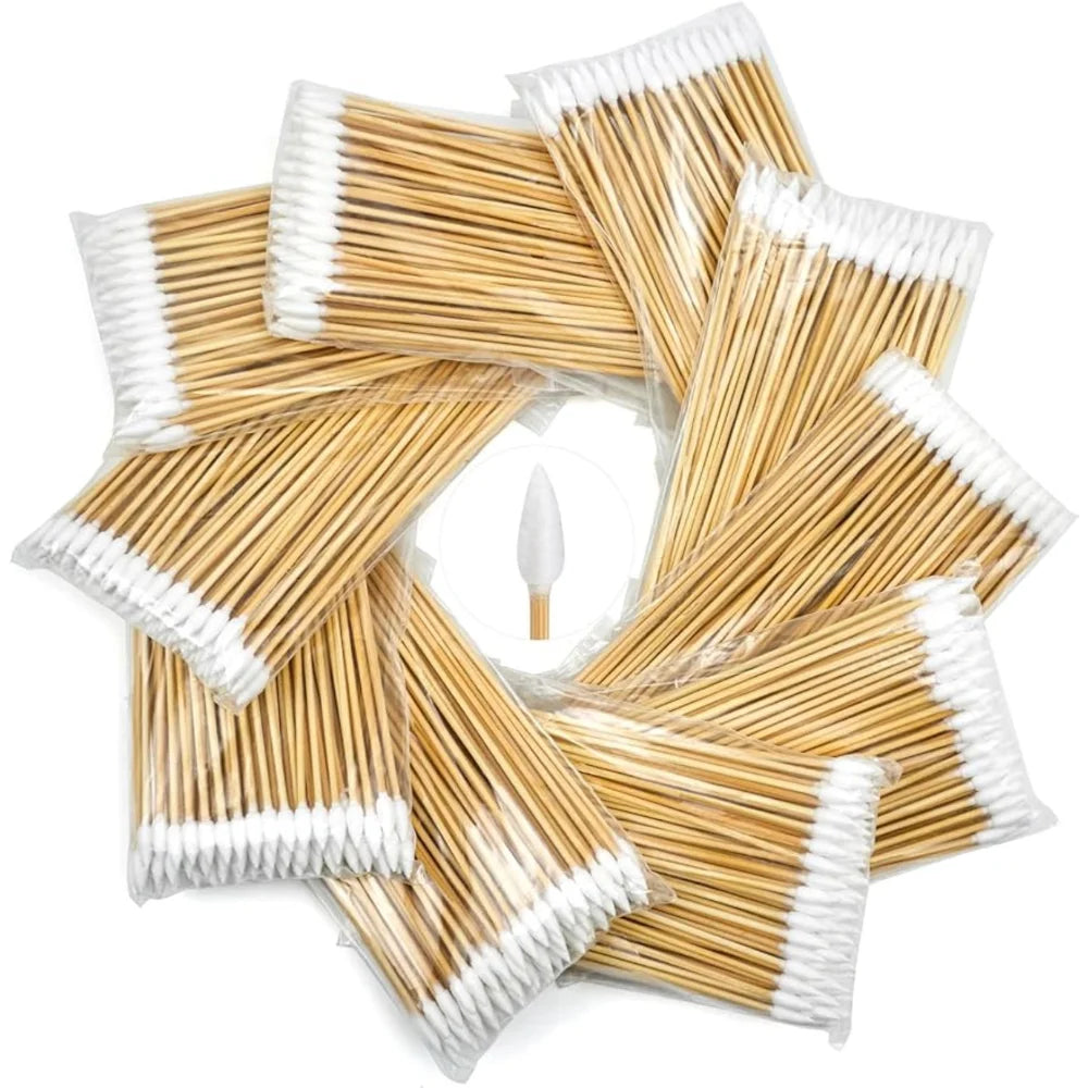 A pile of precision wooden cotton swabs with white tips and wrapped in clear plastic.
