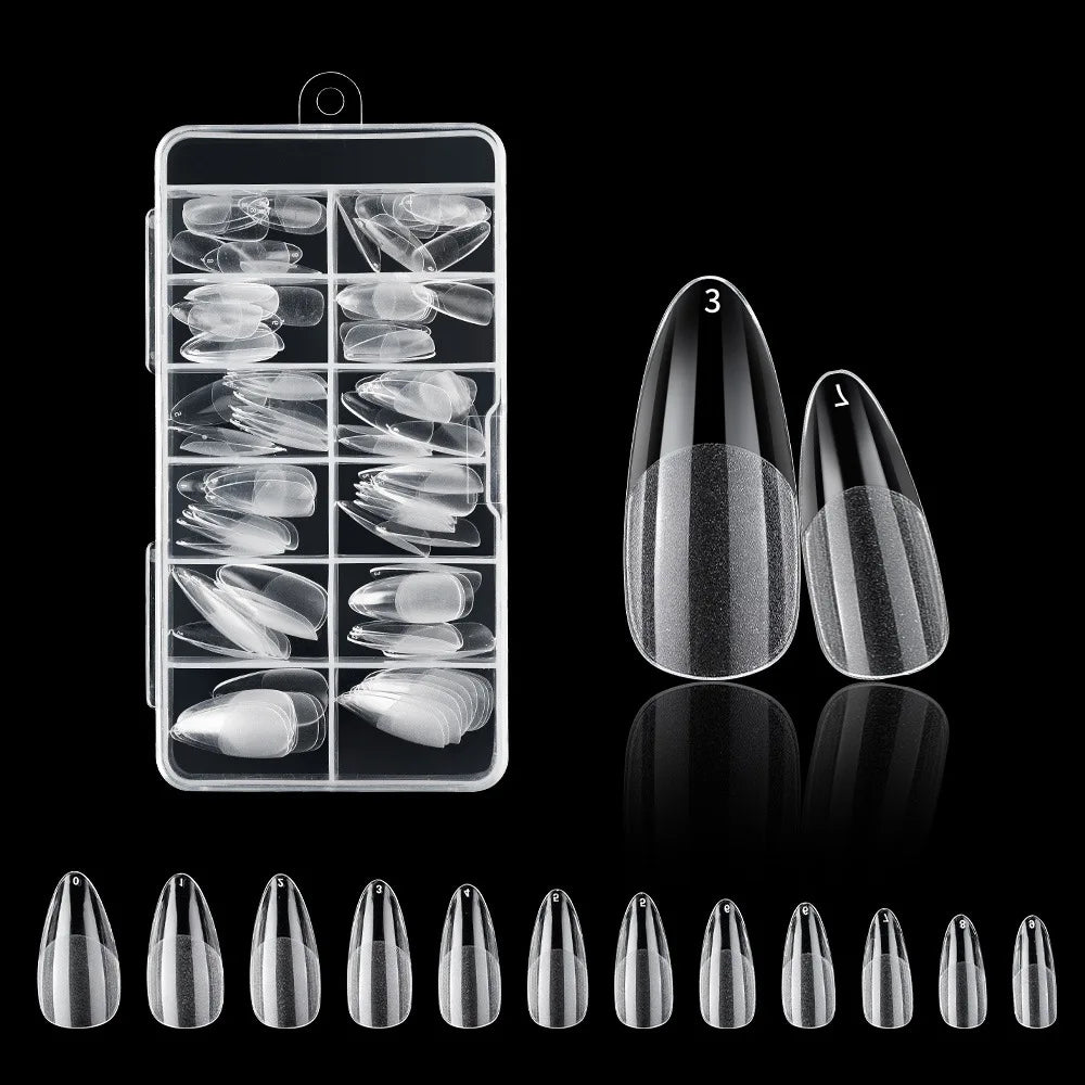 A collection of frosted French false nails in various natural finishes displayed on a clear plastic tray and individual nails