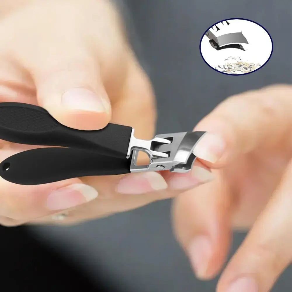A hand holds a black stainless steel slant edge nail clipper, showing the tool and its serrated edge.