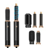 A collection of five professional hair styling tools including a dryer and various brushes in black and gold.