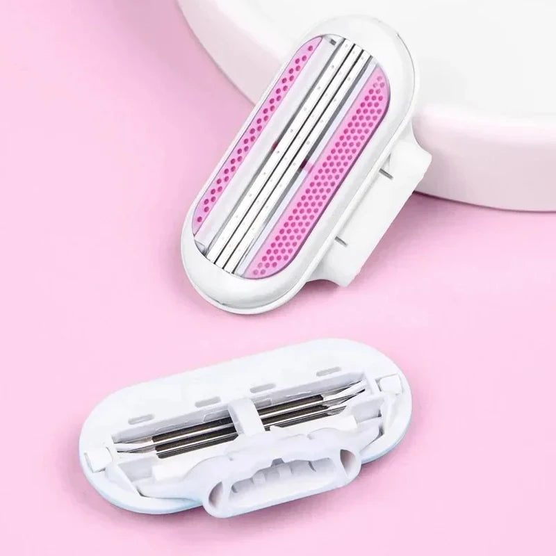 A white replacement shaving blade set with three pink-tipped blades is shown on a pink background.