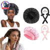 A set of black and pink heatless hair curlers, a satin sleep cap, and claw clips shown on a model's hair.