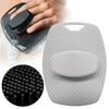 A gray silicone body scrubber with a round pad, shown next to a hand and a close-up of the textured surface.