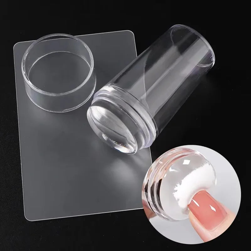 A transparent silicone nail art stamper and scraper set displayed on a clear plastic holder.