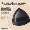 A black triangular cosmetic foundation puff brush showing its surface and grip texture.