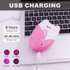 A pink electric hair removal epilator device plugged into a laptop USB port for charging.