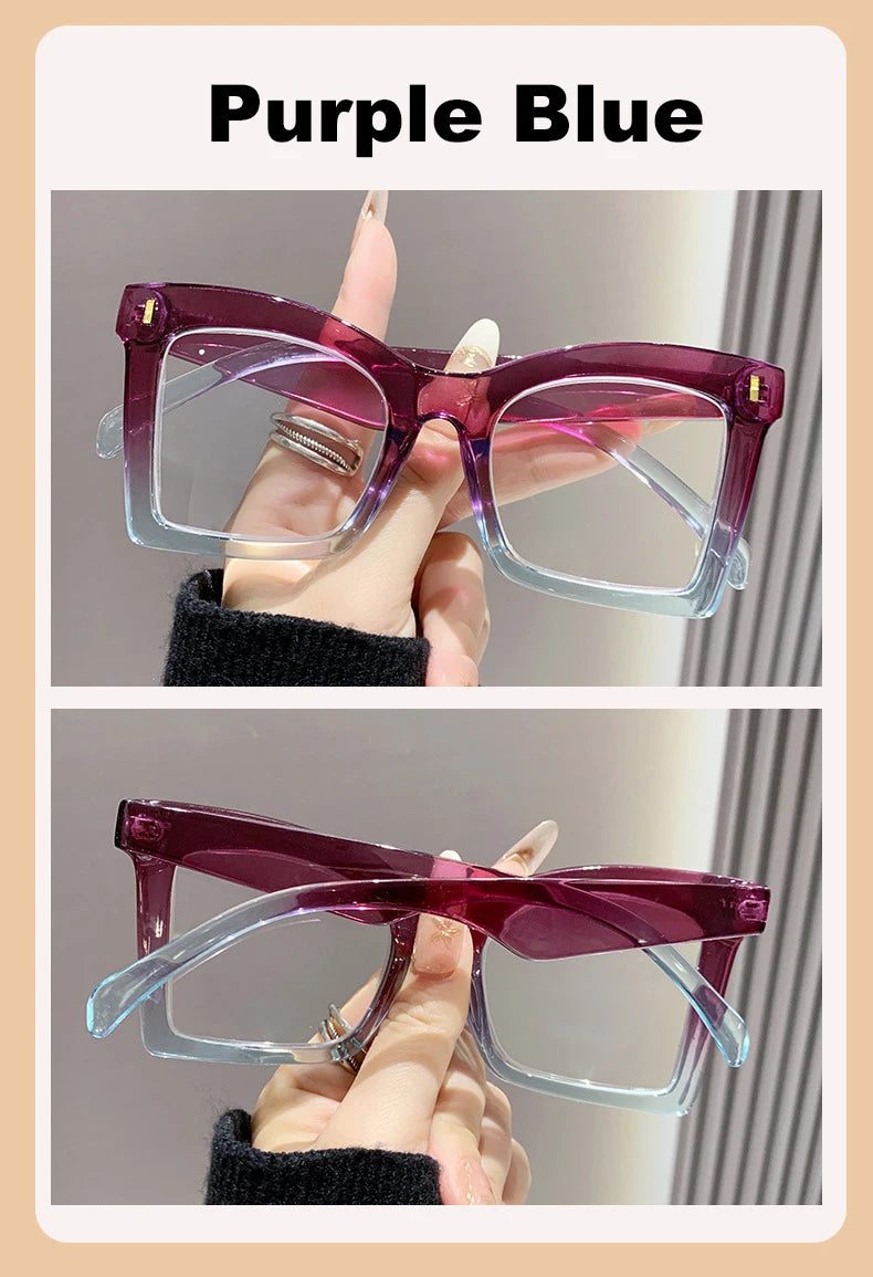 A pair of purple blue square frame reading glasses with light purple lenses being held by a hand.