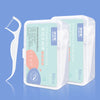 A clear plastic container holding orthodontic floss sticks with green and white labeling.