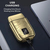 A gold-colored electric shaver charging device is shown on a dark surface.