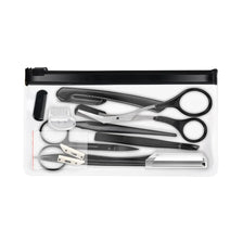 A set of professional eyebrow trimming and grooming tools including tweezers, scissors, and a trimmer, displayed in a black c