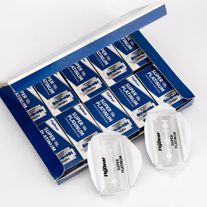 A box of Super Platinum double edge shaving razor blades with individual blades visible.