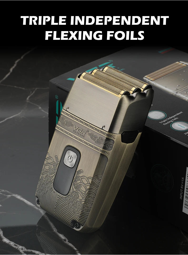A close-up of a triple independent flexing foil hair trimmer in a gold and silver casing resting on a dark surface.