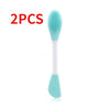 Dos cepillos para limpiar y mascarillas faciales de silicona con cabezales verde azulado y mangos blancos.