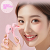 A woman is using a pink frameless heated eyelash curler for curling lashes.