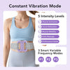 A woman is wearing a light blue body massage ring on her abdomen, demonstrating five intensity levels and three frequency mod