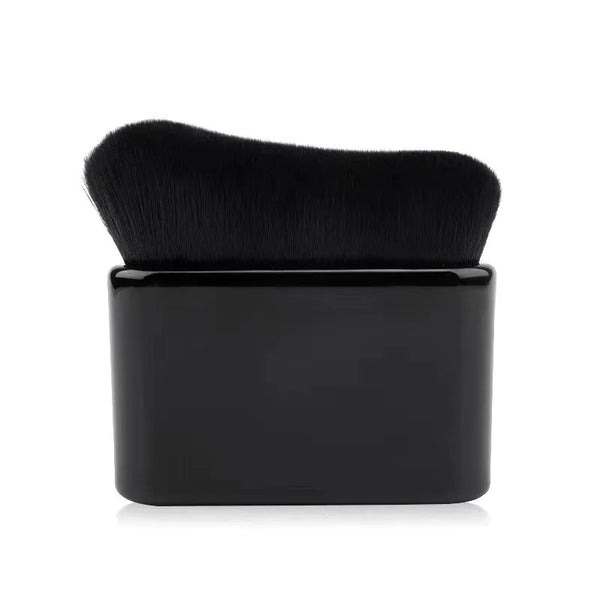 A black makeup brush with a dense, tapered tip is shown against a white background.