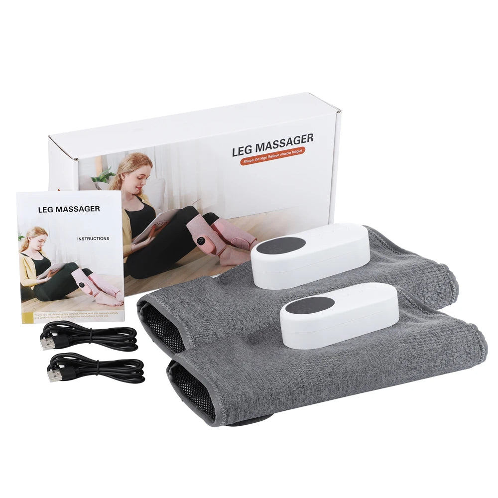 Graues elektrisches Bein-Massagergerät und Zubehör neben der Verpackung