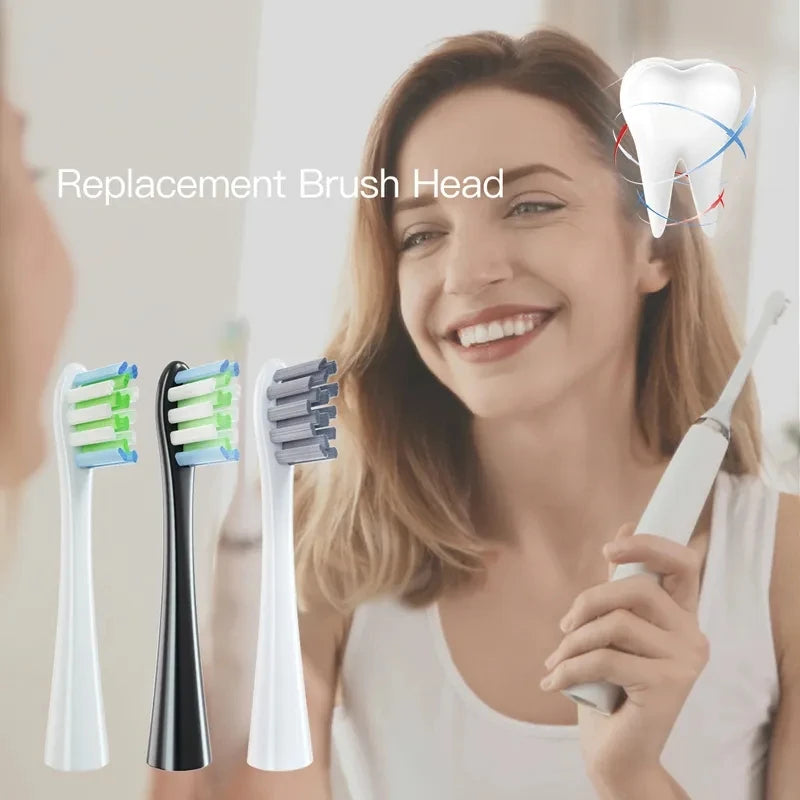 A woman is holding a white electric toothbrush and several replacement brush heads.